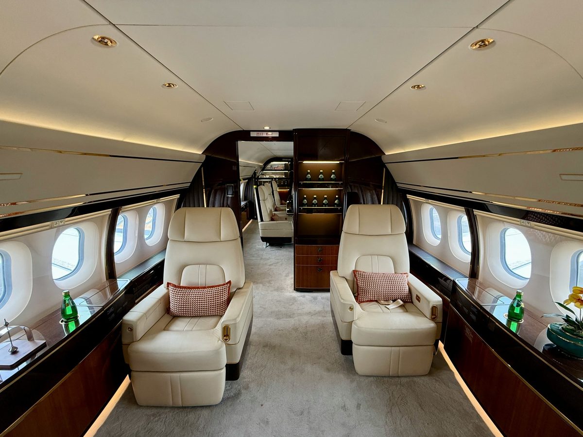 Private jet cabin with cream leather seats